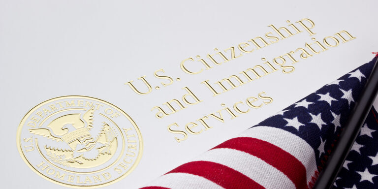 Photograph of USCIS letterhead with an American flag overlapping.