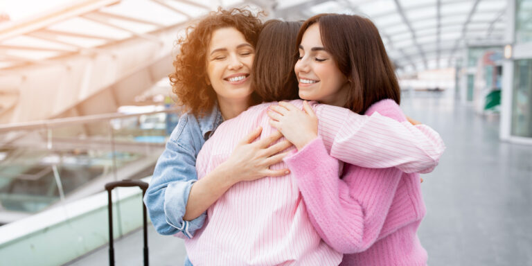 three siblings embrace at the airport after being reunited with help from rozas law firm sibling attorney